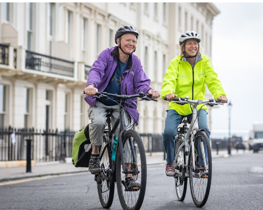 two senior citizens biking
