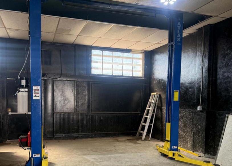 Atlas two-post car lift in garage