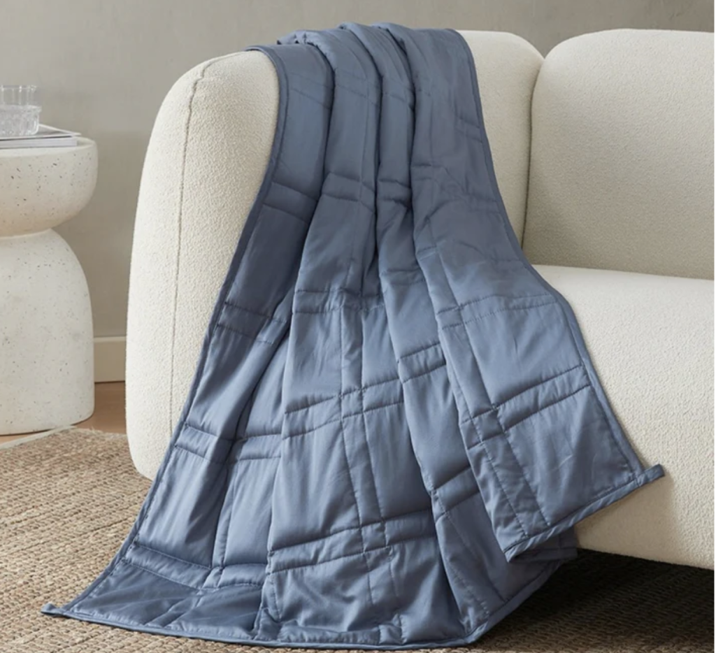 Blue blanket draped over cream sofa