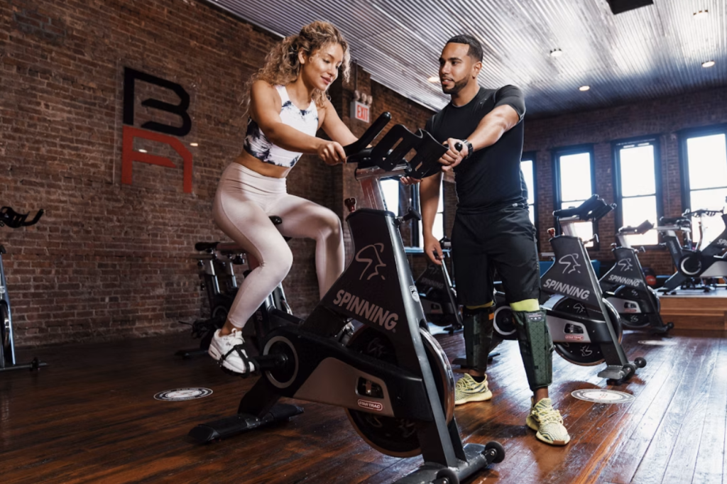 man coaching a woman cyclist